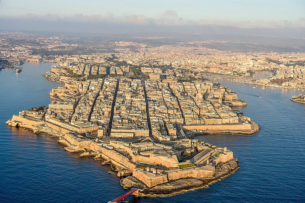 Valletta Waterfront promenade with historic buildings and palm trees